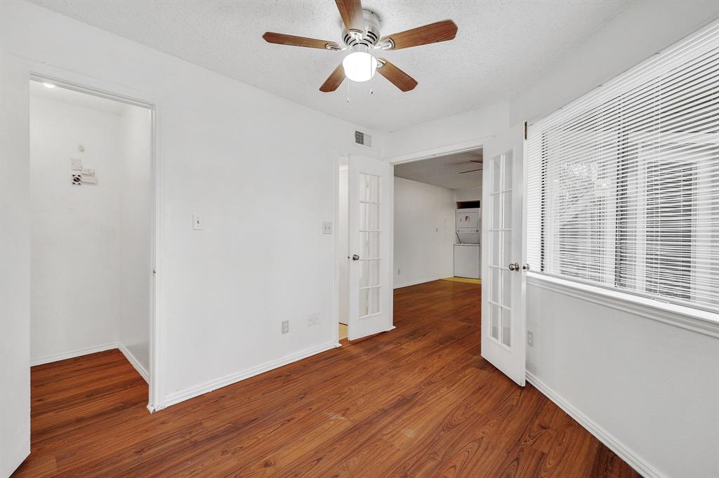 9823 Walnut Street, Unit 304 Dallas, TX 75243 - Photo 3 of 26 a bedroom with wooden floor and a ceiling fan