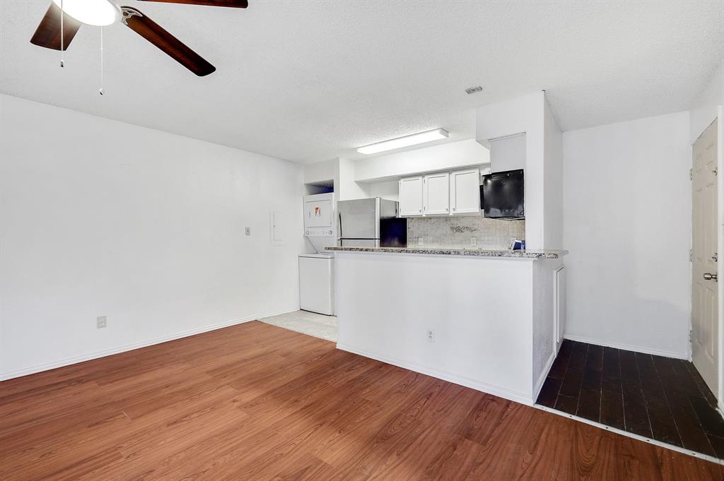 9823 Walnut Street, Unit 304 Dallas, TX 75243 - Photo 6 of 26 a view of a kitchen with a sink and dishwasher wooden floor