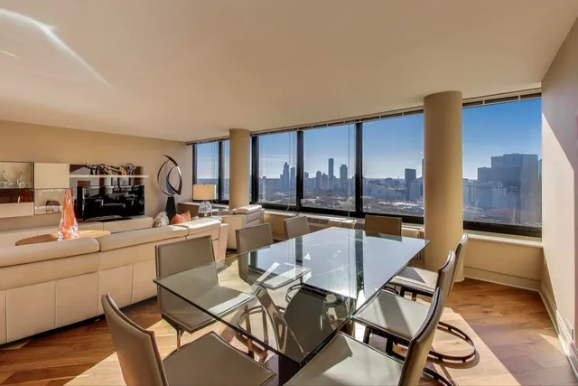a kitchen with granite countertop white cabinets and stainless steel appliances