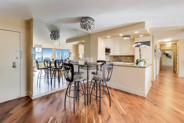 a bedroom with furniture and a large mirror