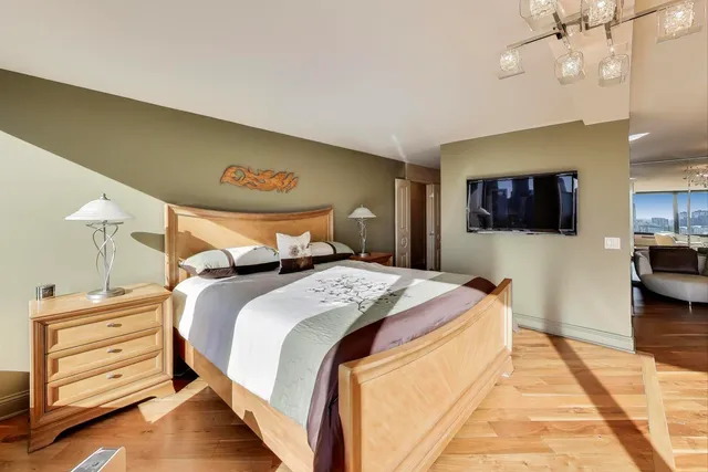 a bathroom with a granite countertop sink a toilet a mirror and shower curtain