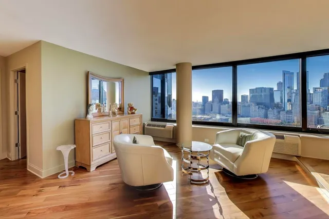 a bathroom with a granite countertop toilet sink and mirror