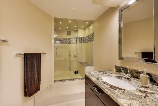 a room with furniture a flat screen tv and wooden floor