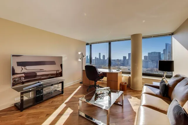 a view of a dining room with furniture large windows and wooden floor