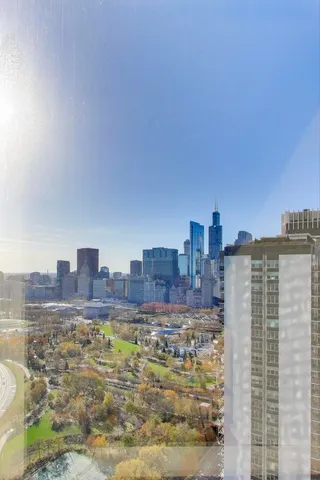 a dining room with furniture and a floor to ceiling window