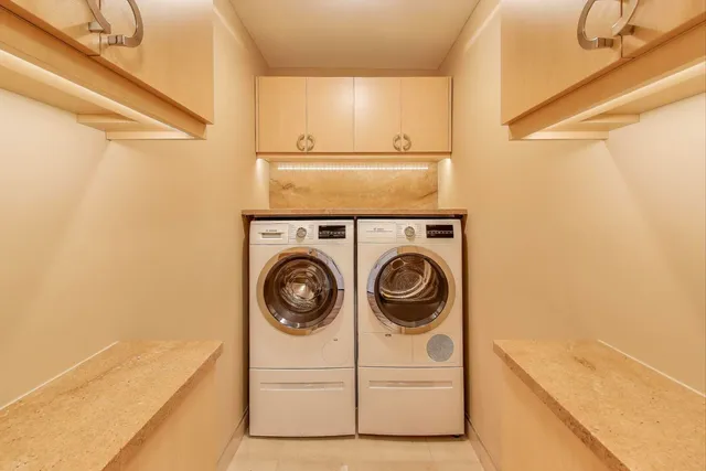 a view of staircase with a washer and dryer
