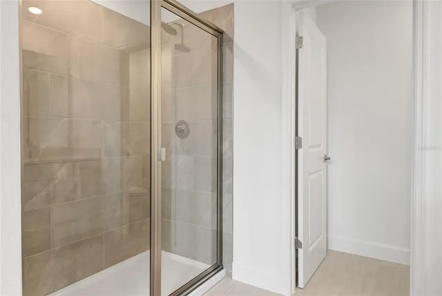a bathroom with a glass shower door