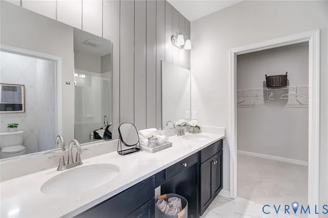 a bathroom with a double vanity sink and a mirror
