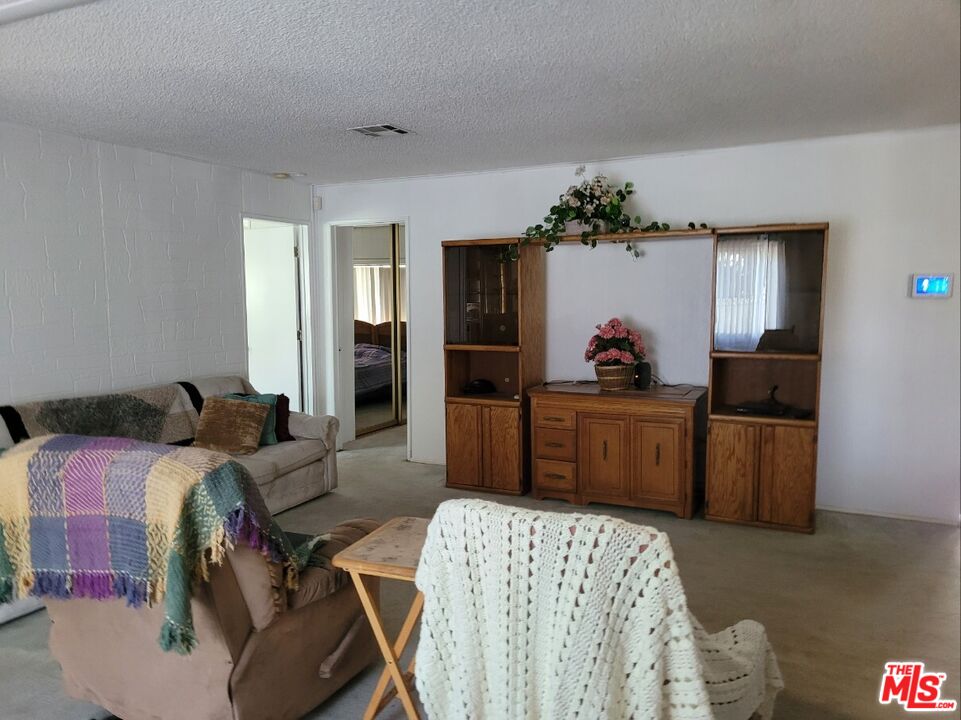 17700 South Avalon Boulevard, Unit 418 Carson, CA 90746 - Photo 12 of 16 a bedroom with a bed and a dresser