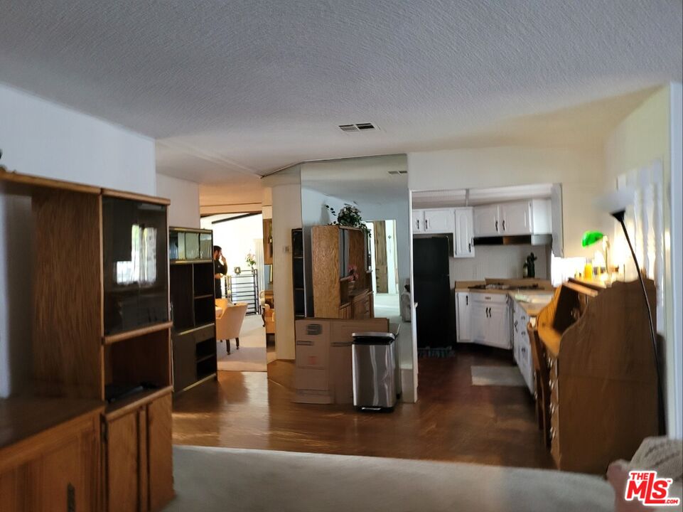 17700 South Avalon Boulevard, Unit 418 Carson, CA 90746 - Photo 14 of 16 a kitchen with stainless steel appliances kitchen island granite countertop a refrigerator a stove and a sink