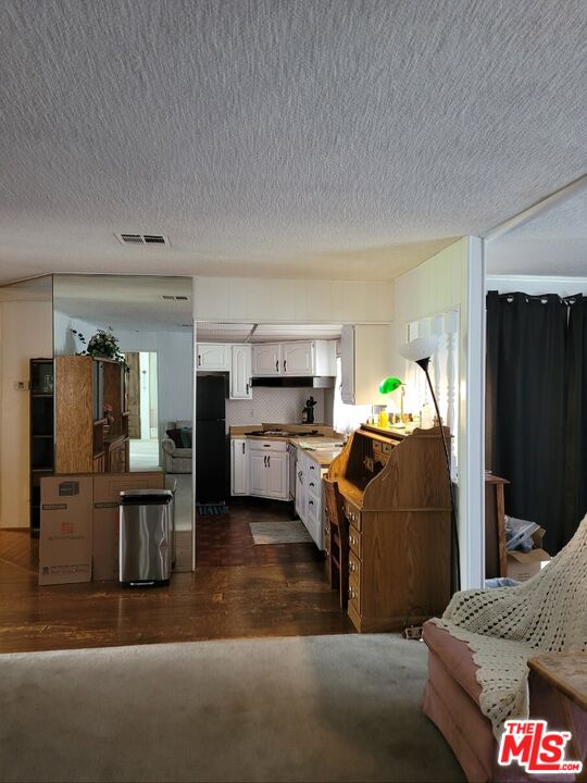 17700 South Avalon Boulevard, Unit 418 Carson, CA 90746 - Photo 15 of 16 a living room with furniture and kitchen view