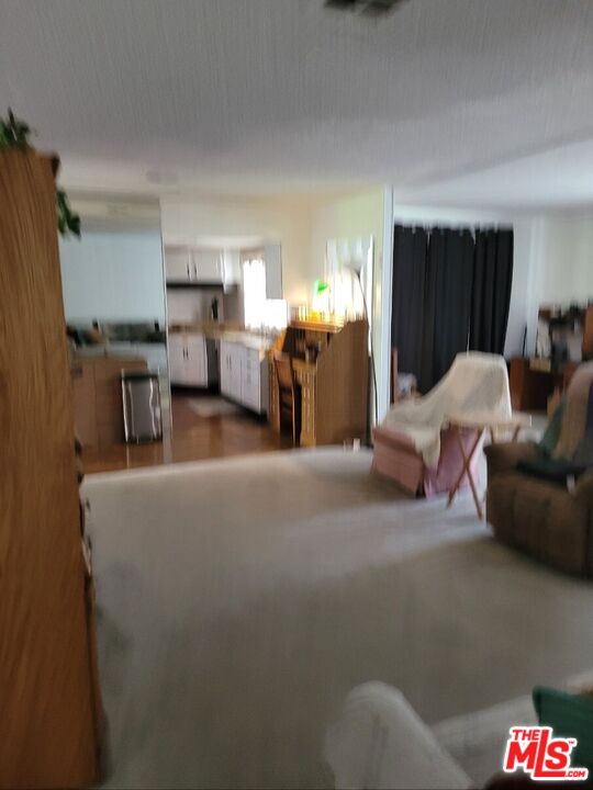 17700 South Avalon Boulevard, Unit 418 Carson, CA 90746 - Photo 4 of 16 a living room with furniture and a walk in closet