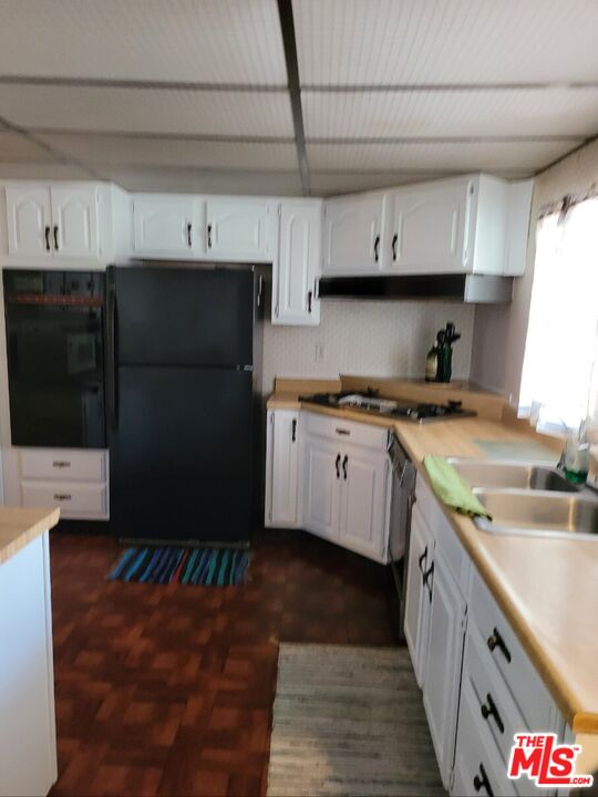 17700 South Avalon Boulevard, Unit 418 Carson, CA 90746 - Photo 10 of 16 a kitchen with stainless steel appliances granite countertop a sink a stove and a refrigerator