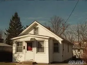 a view of a white house with large windows