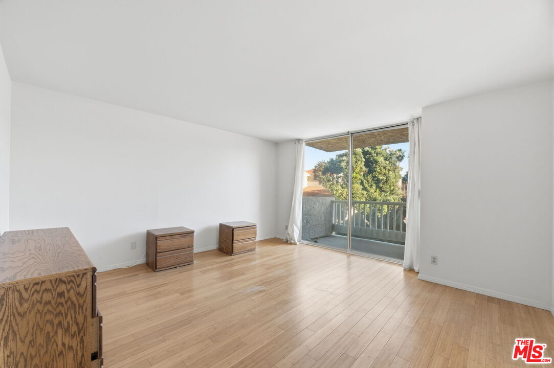 28370 Rey De Copas Lane Malibu, CA 90265 - Photo 13 of 33 a view of an empty room with wooden floor and a window