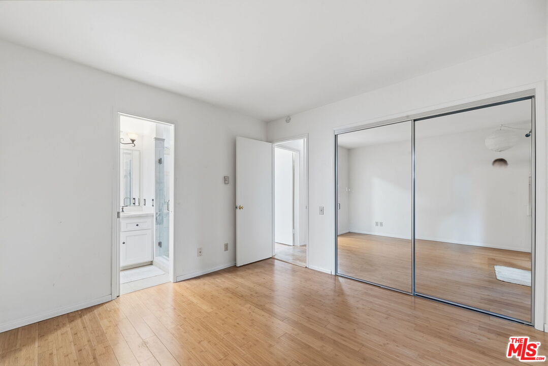 28370 Rey De Copas Lane Malibu, CA 90265 - Photo 21 of 33 a view of an empty room with wooden floor and a bathroom