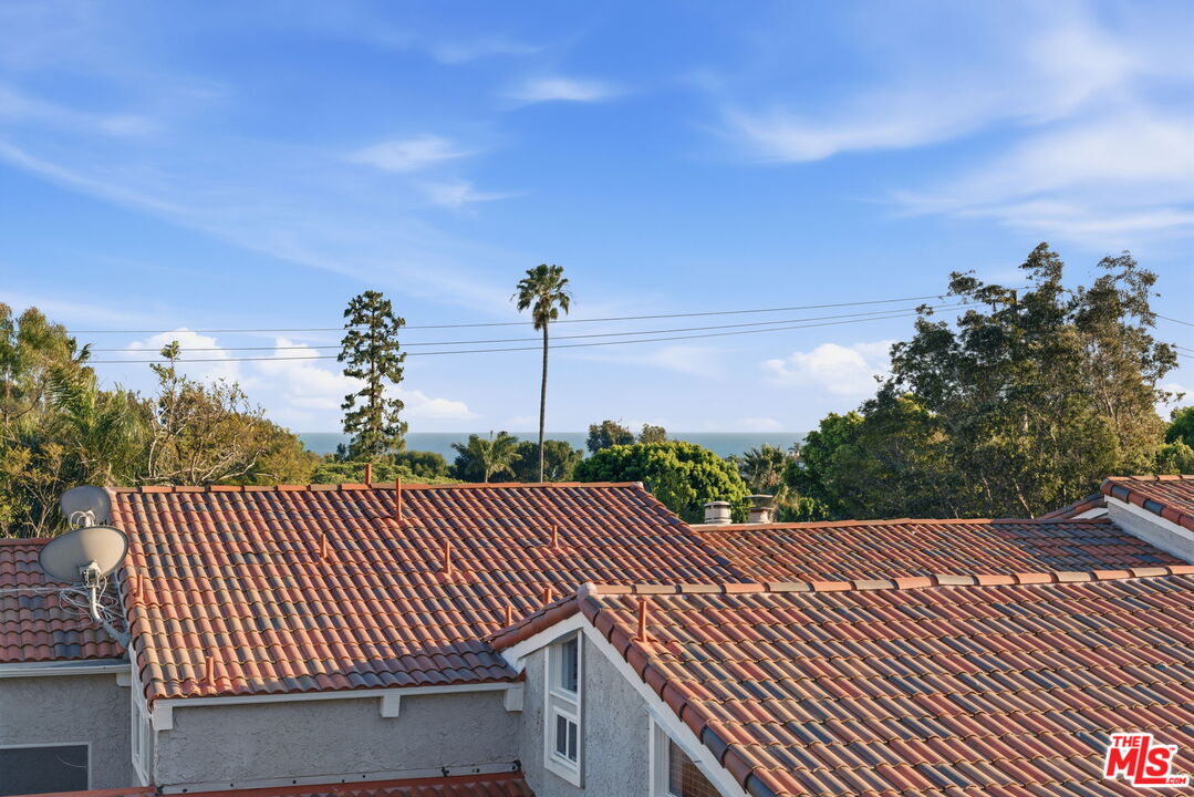 28370 Rey De Copas Lane Malibu, CA 90265 - Photo 27 of 33 a view of a roof deck with wooden floor and fence