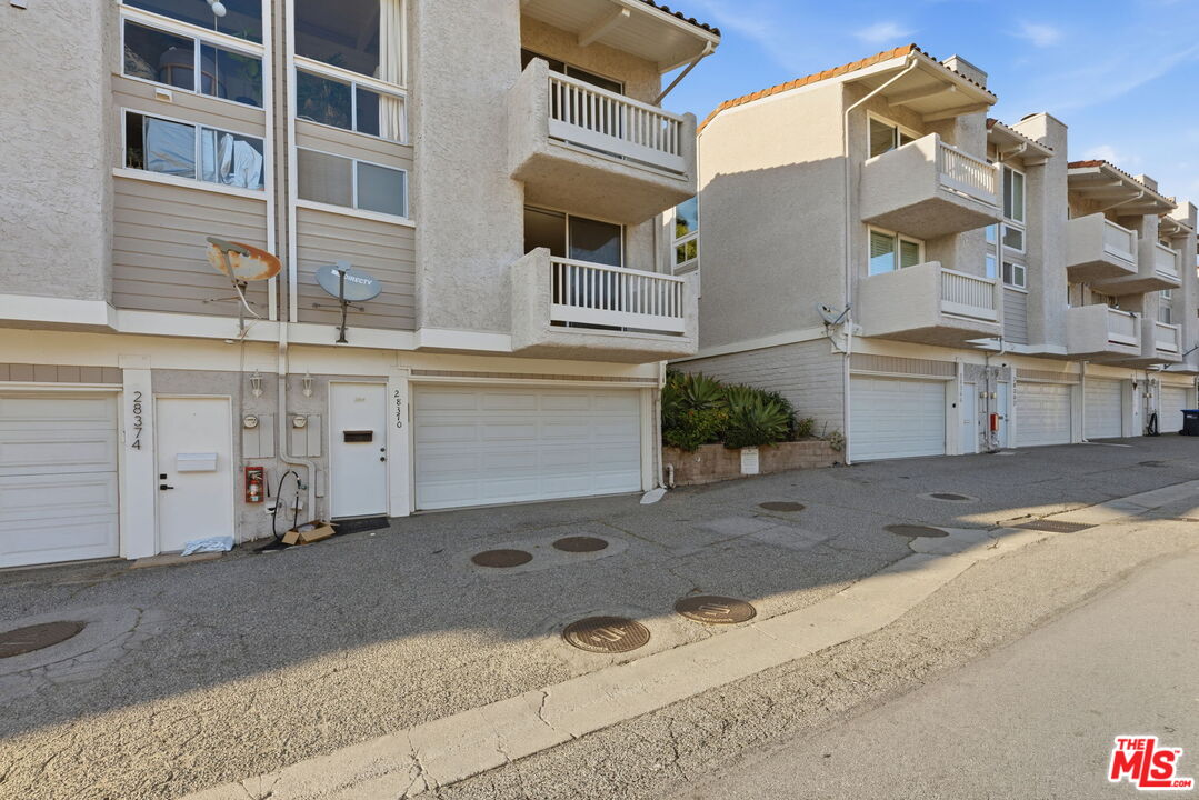 28370 Rey De Copas Lane Malibu, CA 90265 - Photo 32 of 33 a front view of a building with a yard
