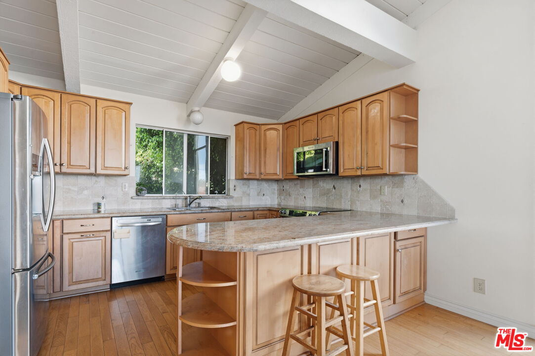 28370 Rey De Copas Lane Malibu, CA 90265 - Photo 8 of 33 a kitchen with a sink cabinets and window
