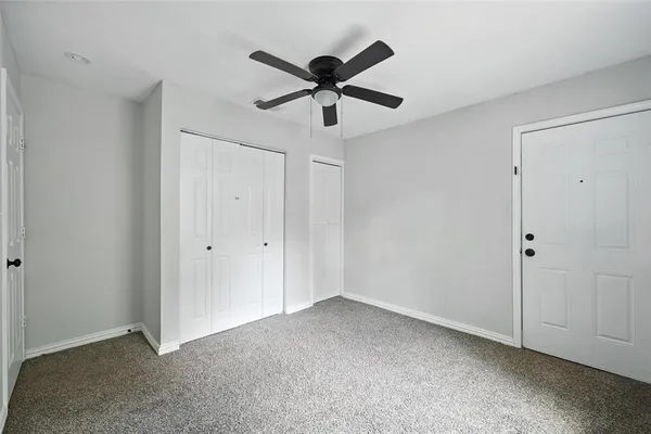 a view of empty room with ceiling fan