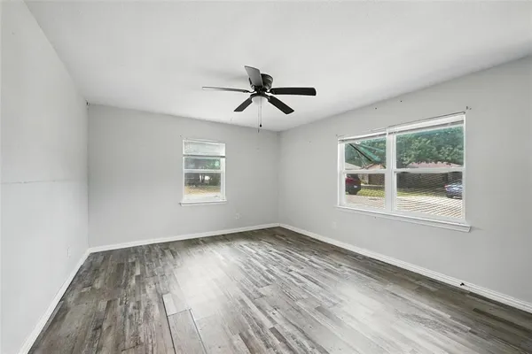 wooden floor in an empty room with a window