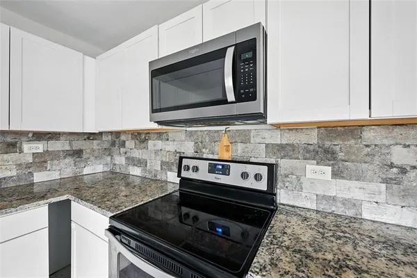 a kitchen with a stove and a microwave