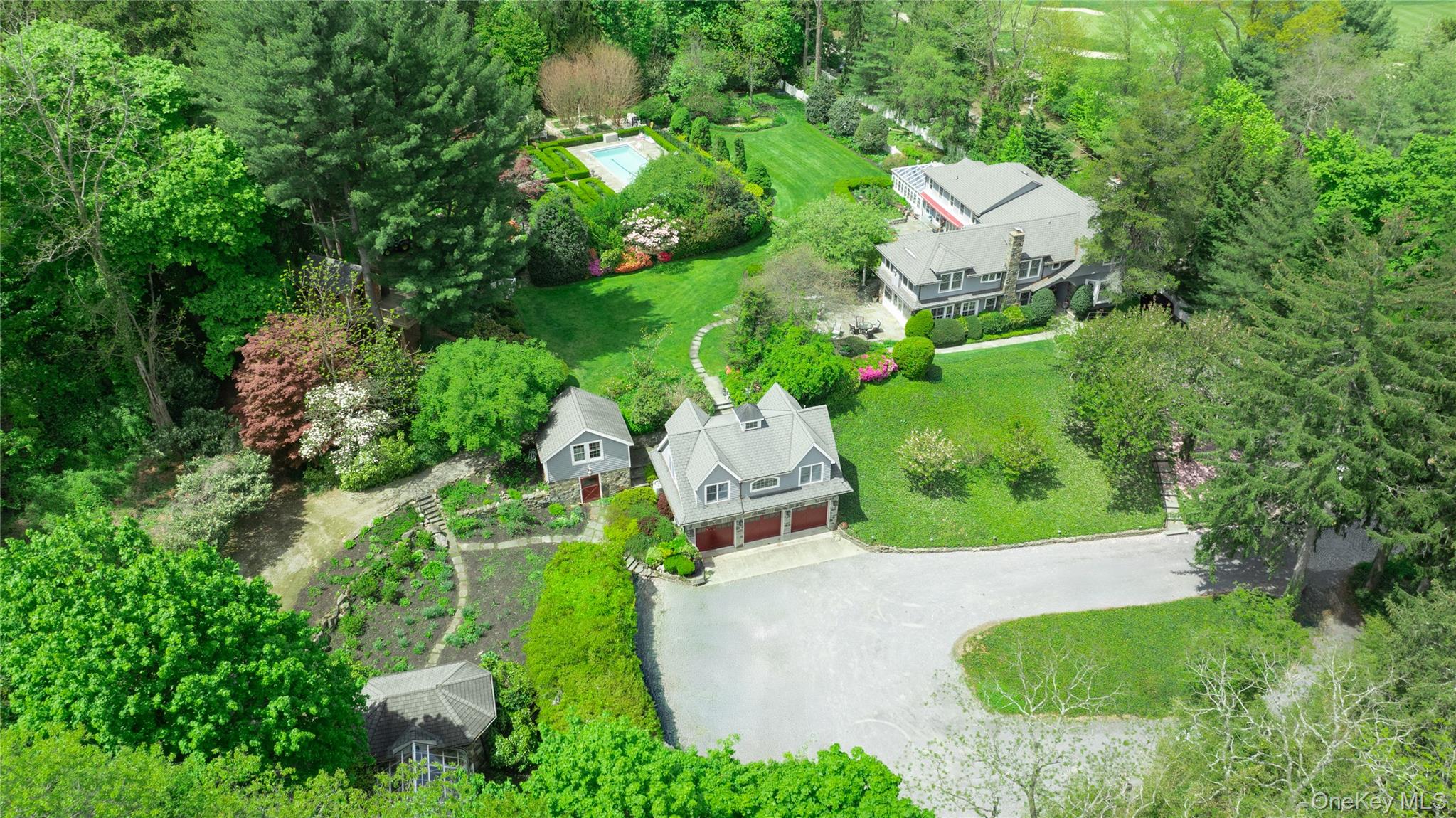 4 Horse Hollow Road Locust Valley, NY 11560 - Photo 1 of 48 an aerial view of a house with swimming pool and garden