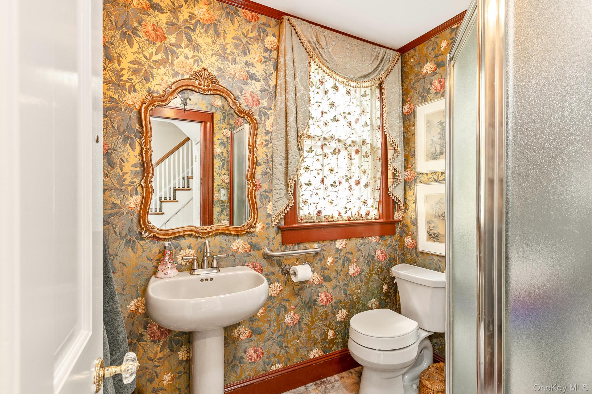 4 Horse Hollow Road Locust Valley, NY 11560 - Photo 22 of 48 a bathroom with a sink and mirror with toilet