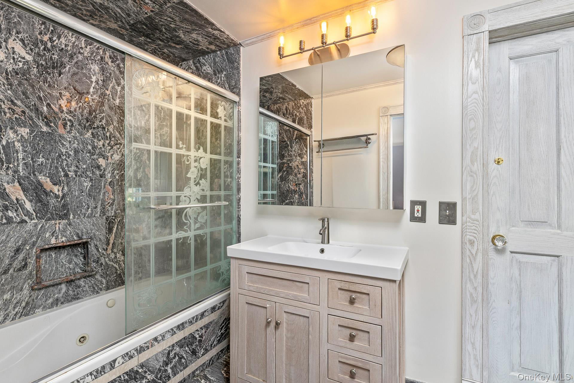 4 Horse Hollow Road Locust Valley, NY 11560 - Photo 30 of 48 a bathroom with a shower sink and mirror
