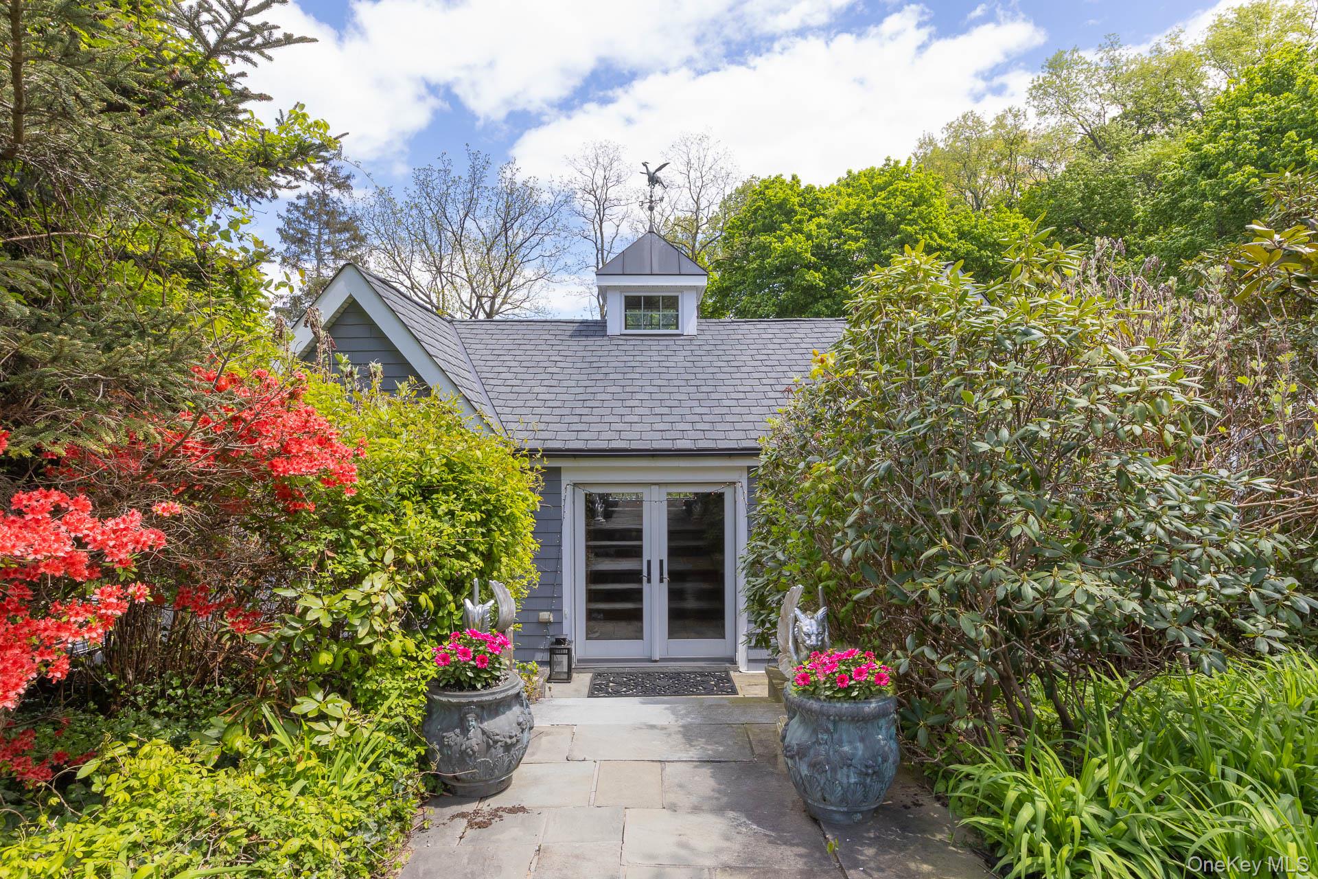 4 Horse Hollow Road Locust Valley, NY 11560 - Photo 33 of 48 a front view of a house with a yard