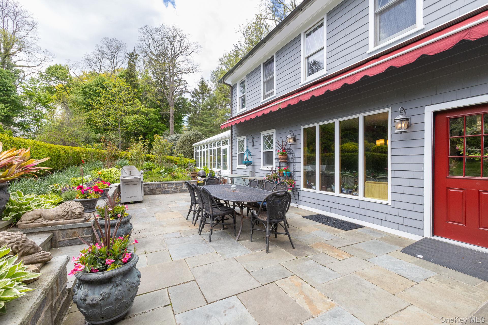 4 Horse Hollow Road Locust Valley, NY 11560 - Photo 38 of 48 a view of a patio with table and chairs and potted plants
