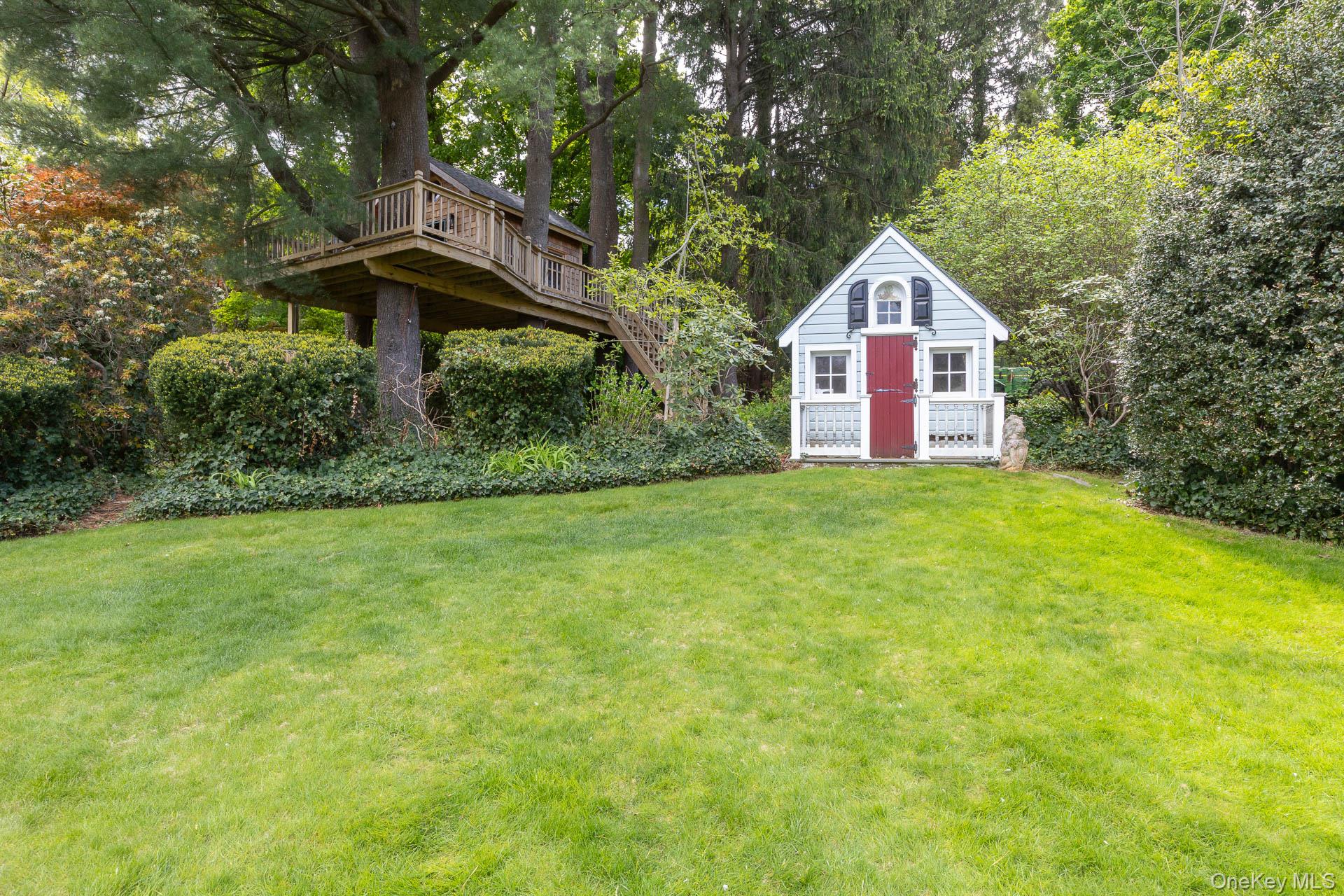 4 Horse Hollow Road Locust Valley, NY 11560 - Photo 45 of 48 a front view of a house with a yard and trees
