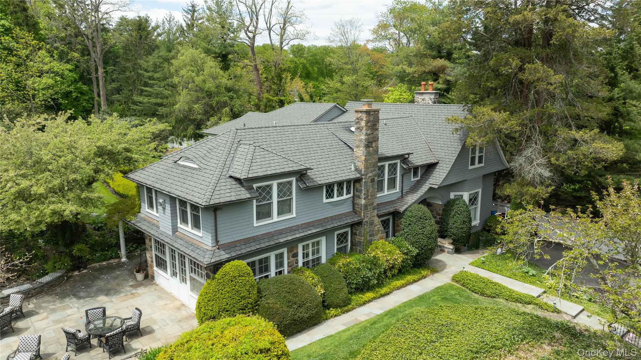 4 Horse Hollow Road Locust Valley, NY 11560 - Photo 5 of 48 an aerial view of a house with a yard table and chairs