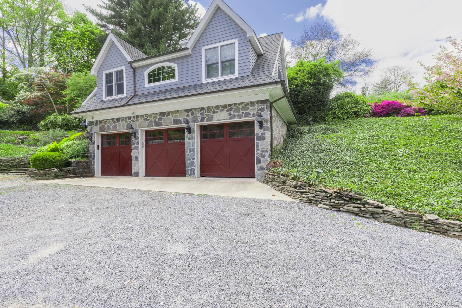 4 Horse Hollow Road Locust Valley, NY 11560 - Photo 6 of 48 a front view of a house with a yard and garage