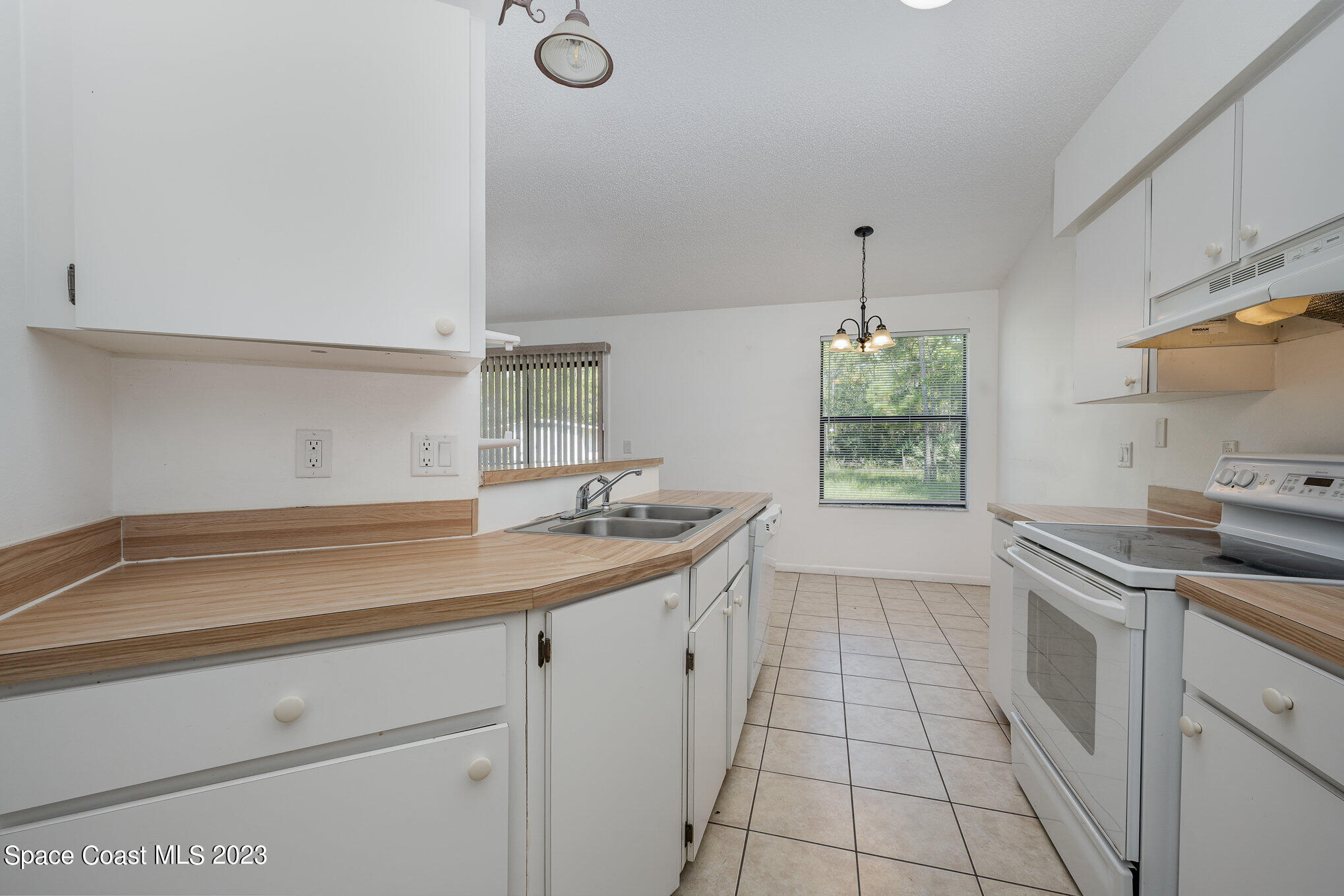 1061 Spring Street Northwest Palm Bay, FL 32907 - Photo 11 of 23 a kitchen with a sink and cabinets