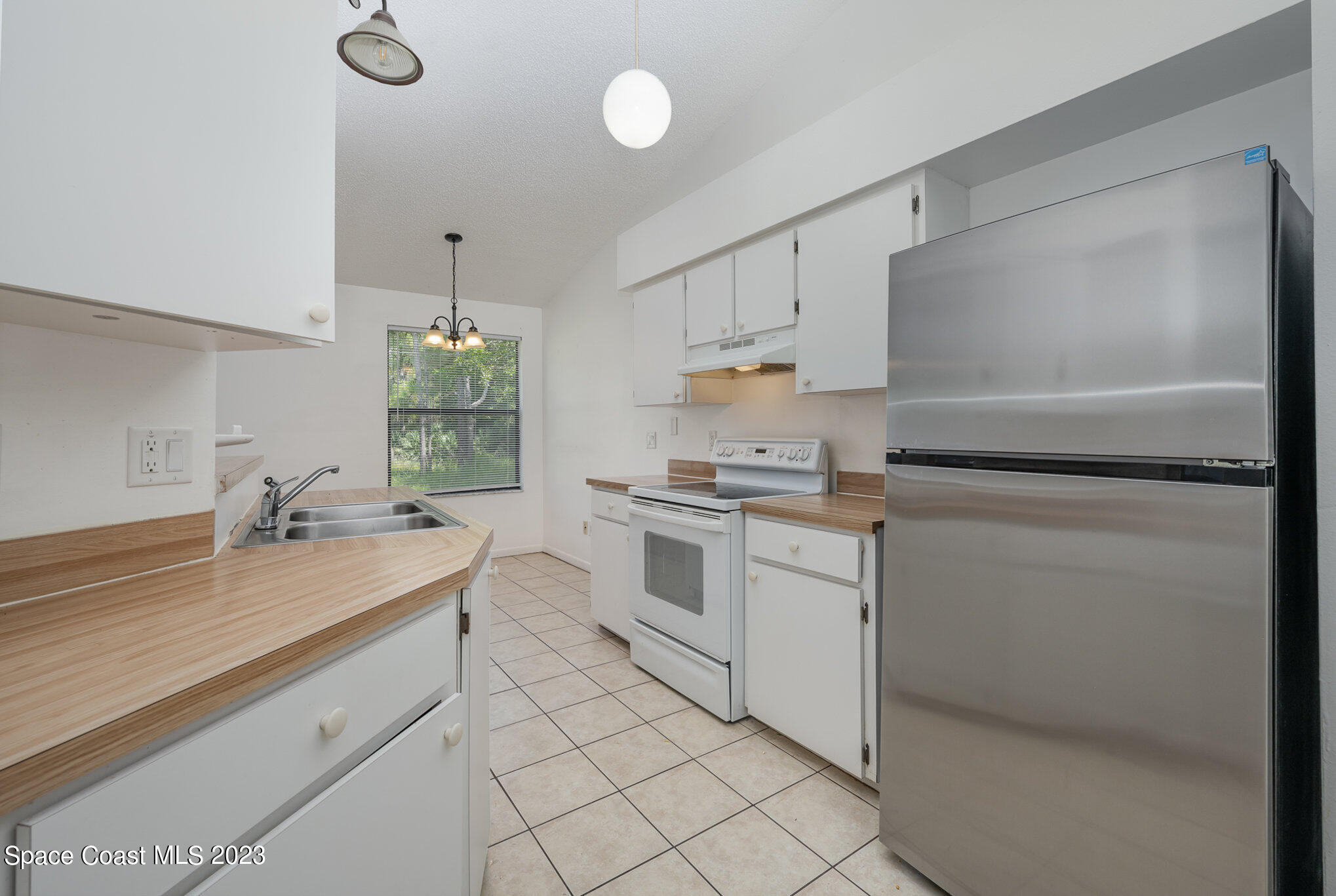 1061 Spring Street Northwest Palm Bay, FL 32907 - Photo 12 of 23 a kitchen with a sink appliances and cabinets