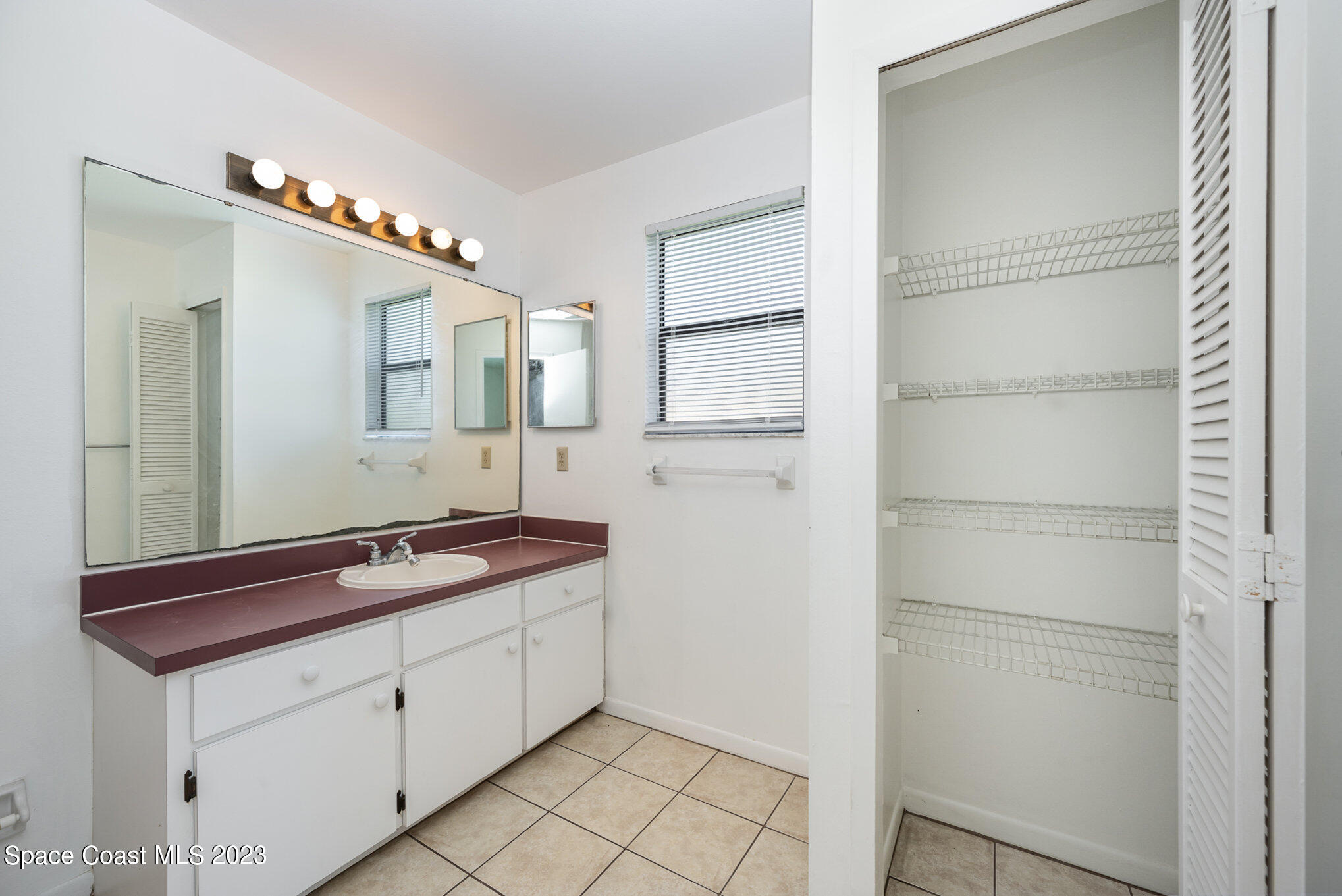 1061 Spring Street Northwest Palm Bay, FL 32907 - Photo 15 of 23 a spacious bathroom with a double vanity sink and mirror