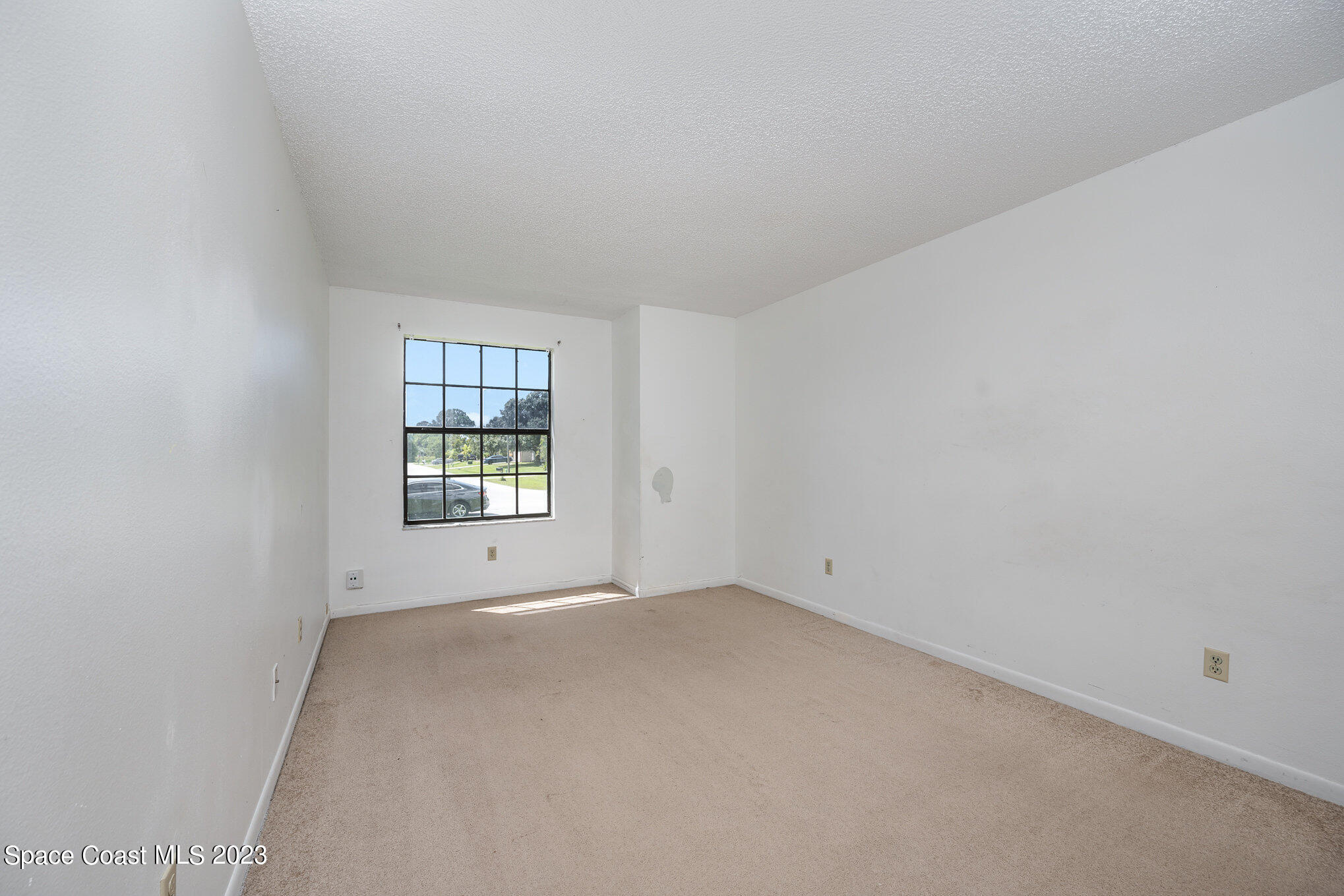 1061 Spring Street Northwest Palm Bay, FL 32907 - Photo 18 of 23 an empty room with a window