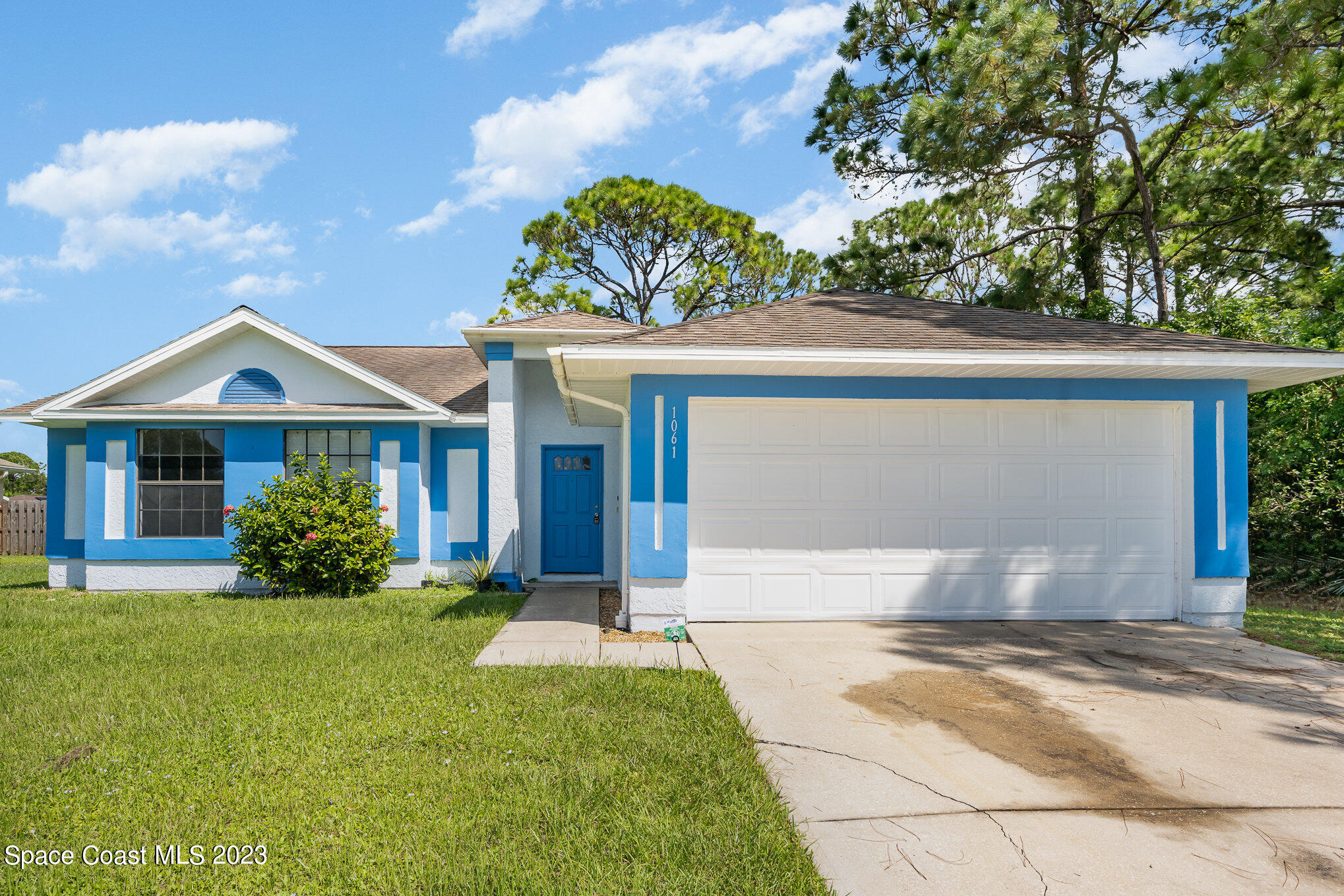 1061 Spring Street Northwest Palm Bay, FL 32907 - Photo 3 of 23 front view of house with a yard