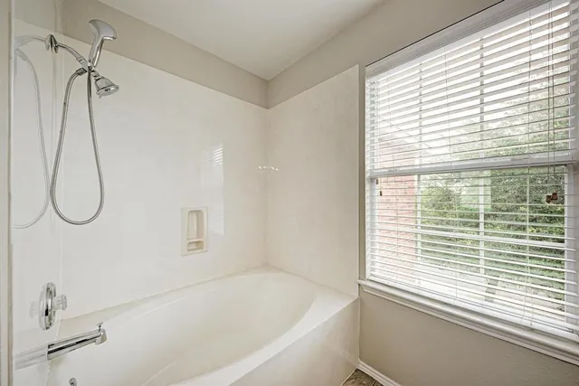 a bathroom with a bathtub and a shower