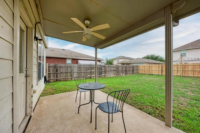 a view of a porch with a table and chairs