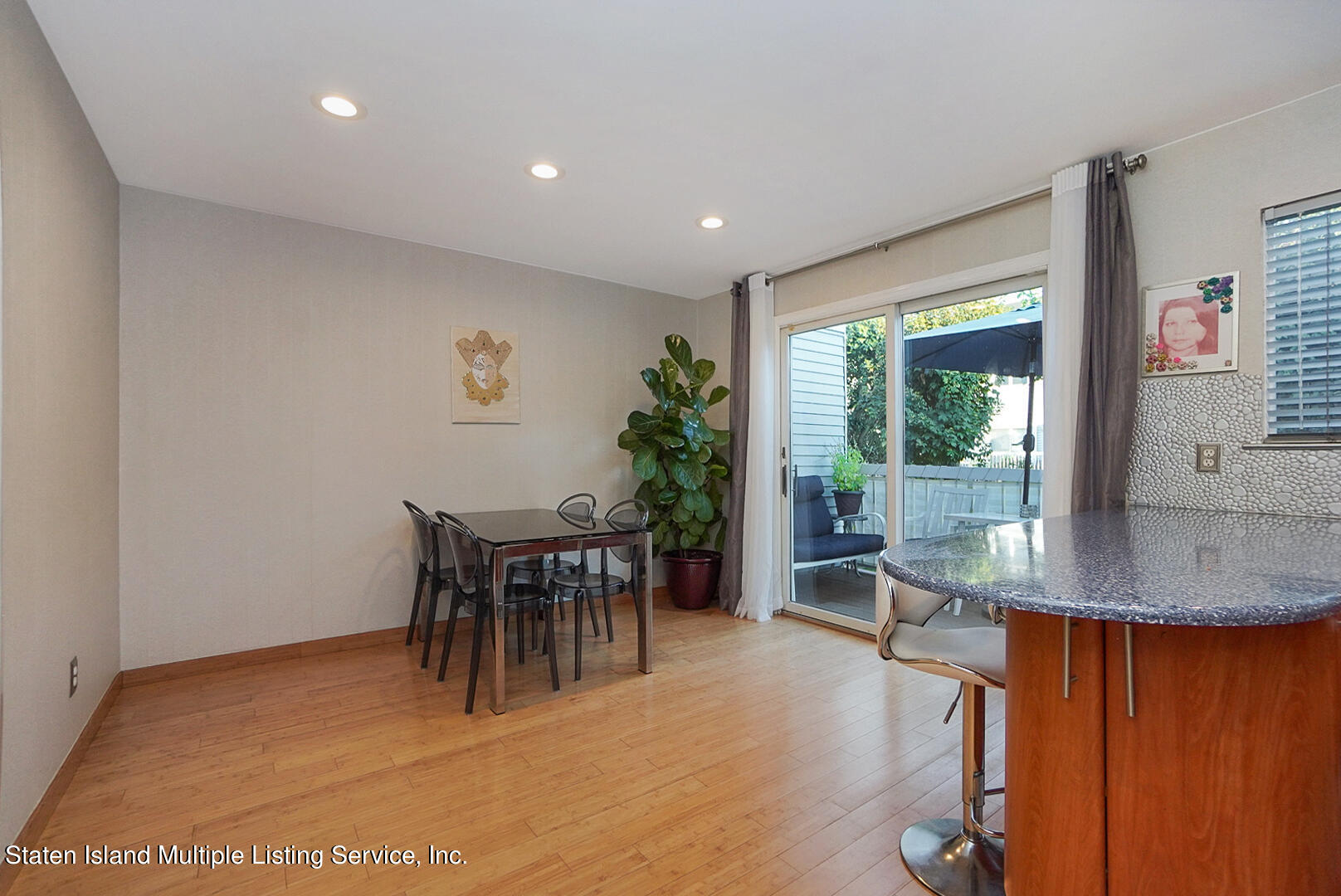 114 Commodore Drive Staten Island, NY 10309 - Photo 13 of 31 a dining room with furniture a rug and a large window