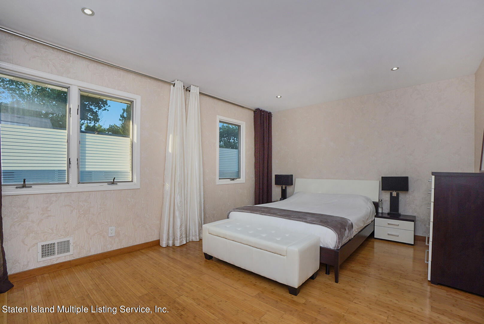 114 Commodore Drive Staten Island, NY 10309 - Photo 16 of 31 a bedroom with a bed and a night stand