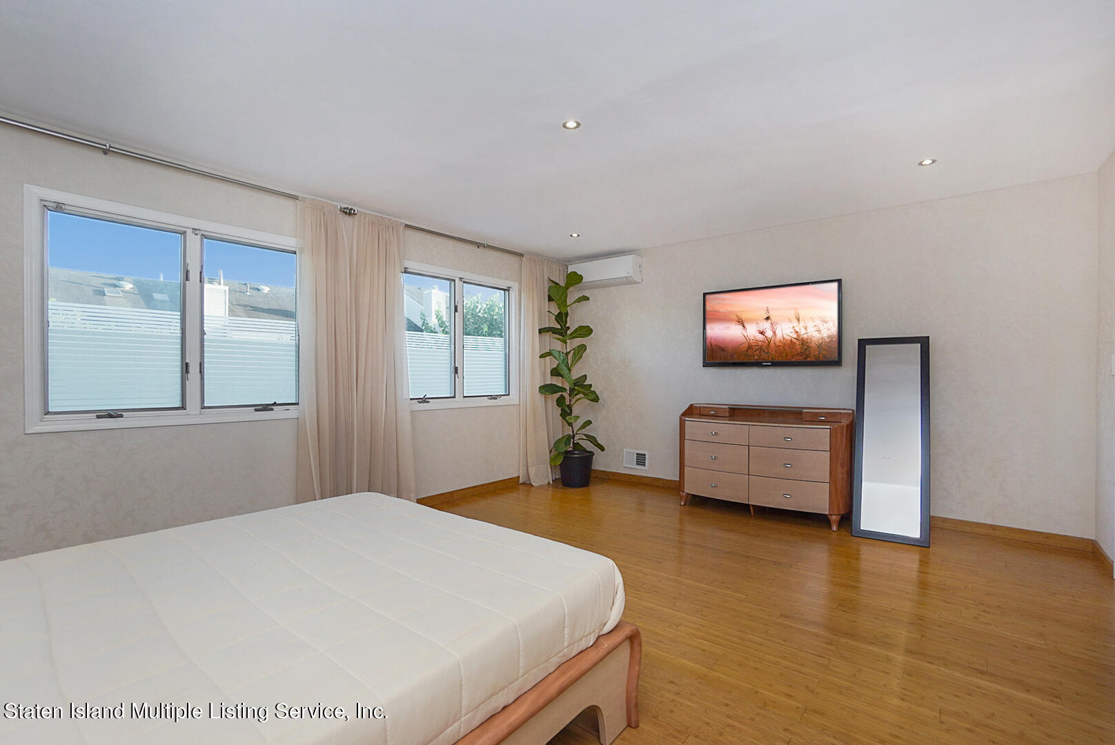 114 Commodore Drive Staten Island, NY 10309 - Photo 19 of 31 a bedroom with a bed and a flat screen tv