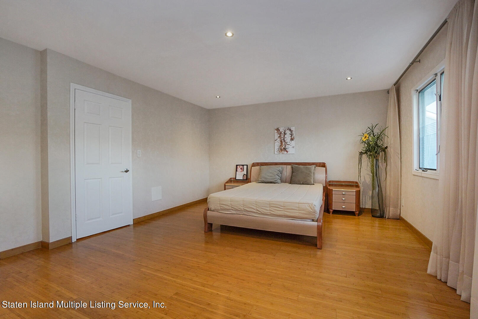 114 Commodore Drive Staten Island, NY 10309 - Photo 20 of 31 a bedroom with a bed and a night stand