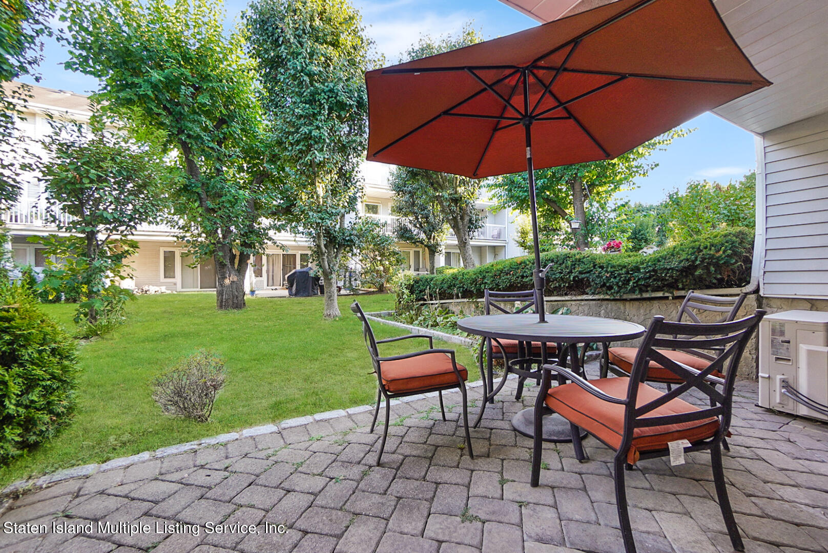 114 Commodore Drive Staten Island, NY 10309 - Photo 24 of 31 a patio with a patio table and chairs