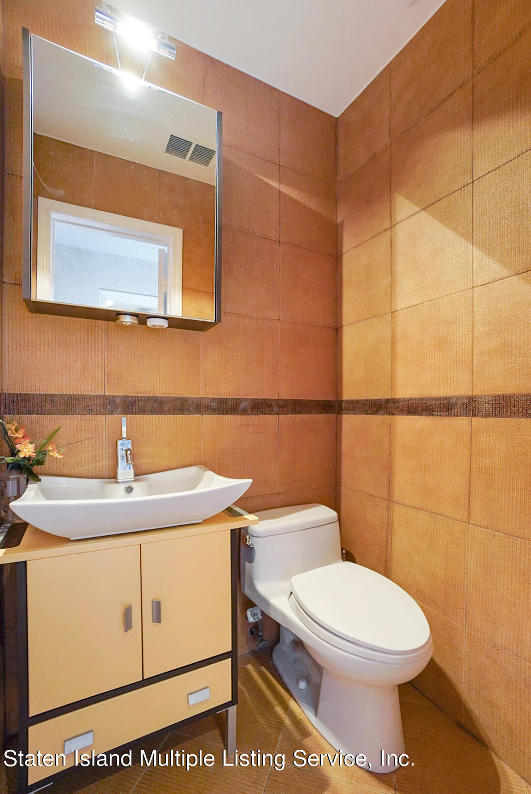 114 Commodore Drive Staten Island, NY 10309 - Photo 6 of 31 a bathroom with a sink a toilet and mirror