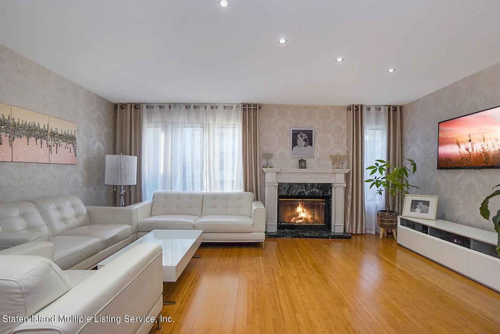 114 Commodore Drive Staten Island, NY 10309 - Photo 8 of 31 a living room with furniture and a fireplace