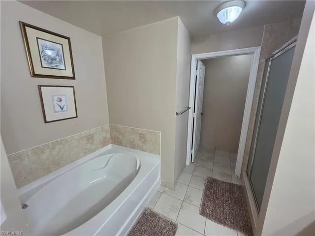 a bathroom with a bathtub and a shower