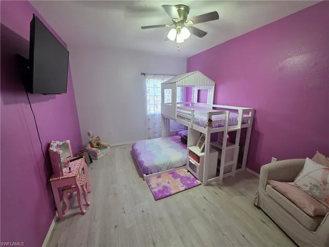 a bedroom with furniture and a flat screen tv